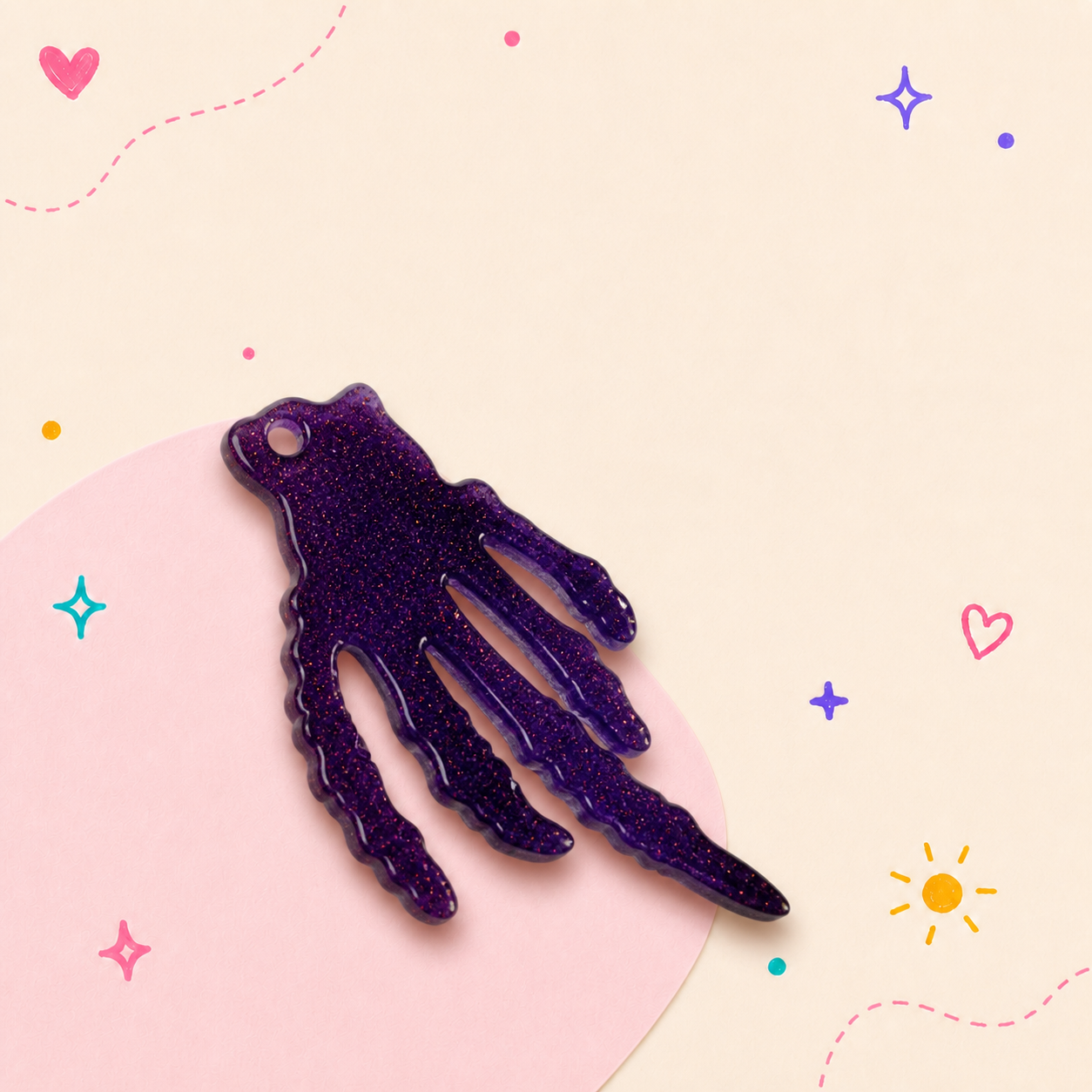 Purple resin hand charm with floral detail and gold hardware