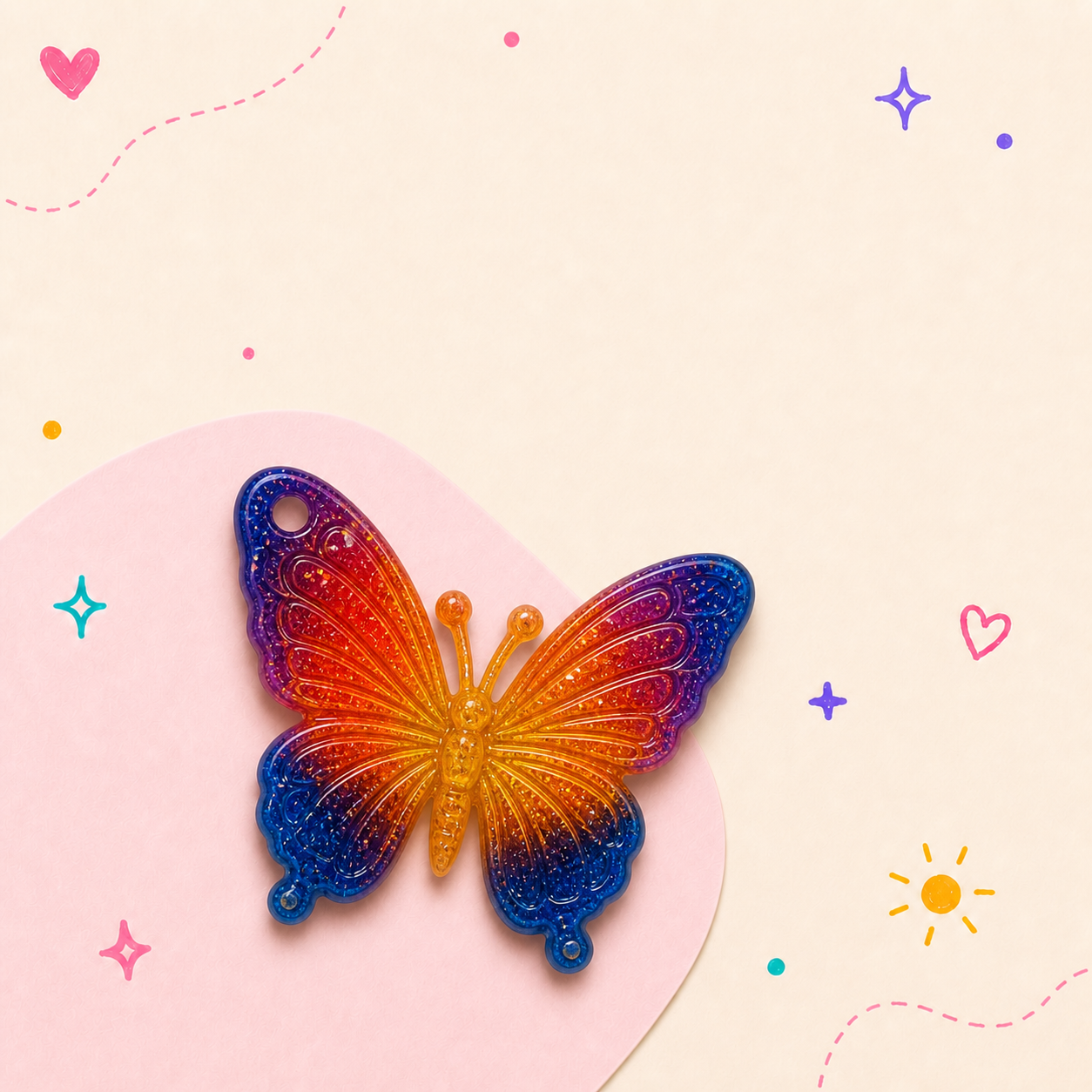 Small butterfly resin charm with colorful wings and gold hardware